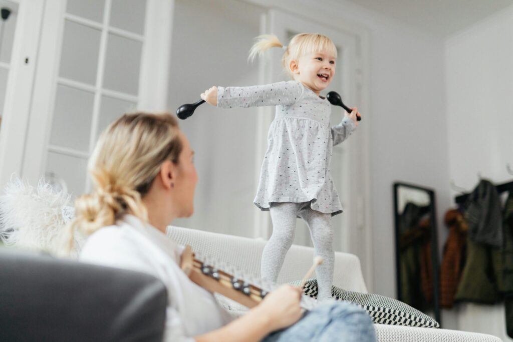A lively toddler enjoying playtime on the sofa, creating happy family moments indoors.